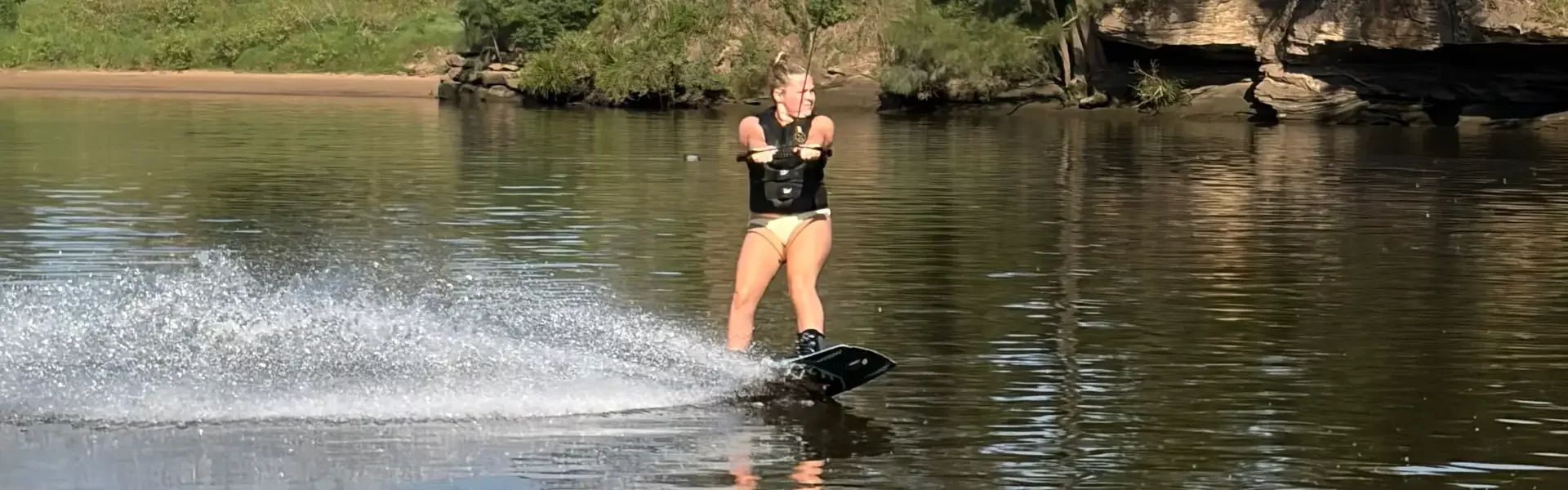 Photo of female wakeboarding on Hyperlite Slate Wakeboard